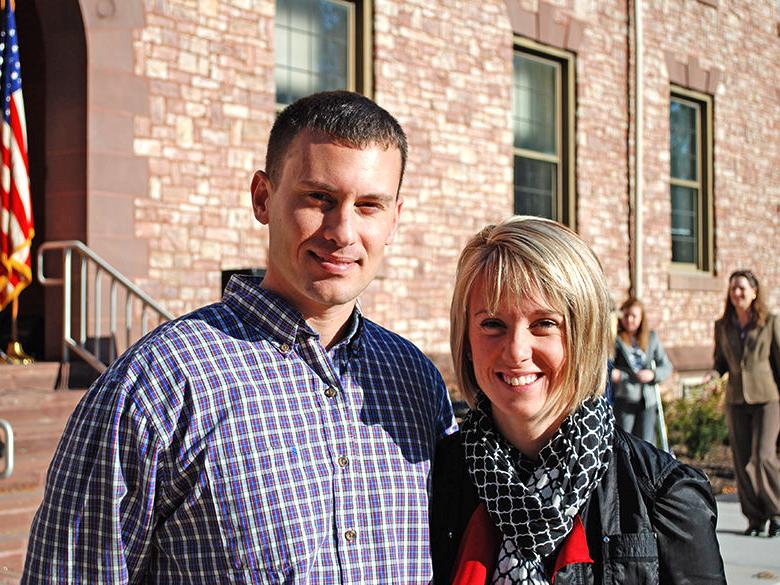 Student veteran and his wife stand outside Conklin Hall